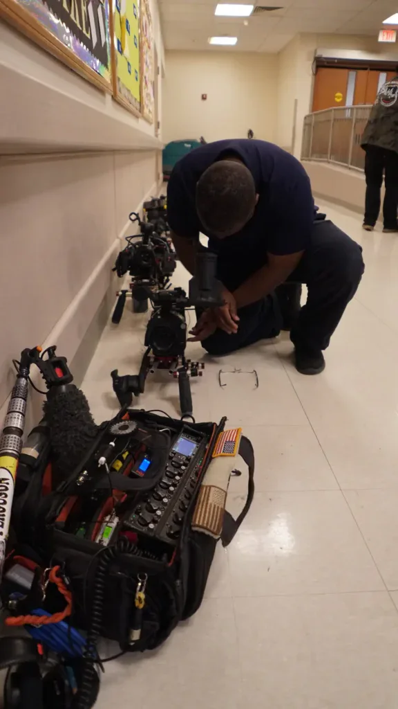 cameras and film equipment in a school hallway