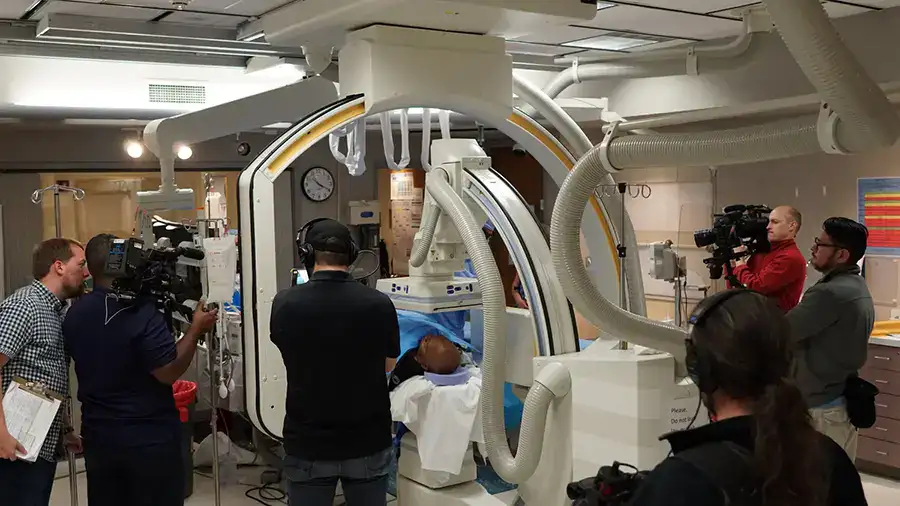 camera crew in a hospital room