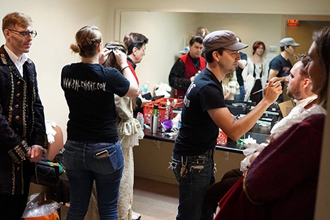 people doing makeup to prepare for filiming