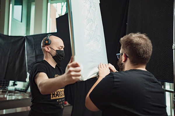 two men putting up a film set