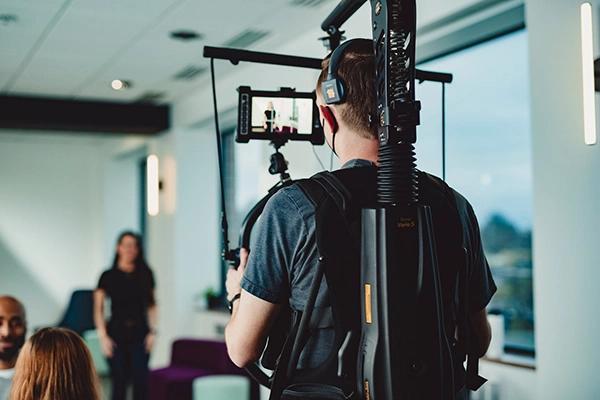 camera guy wearing stabilizer equipment