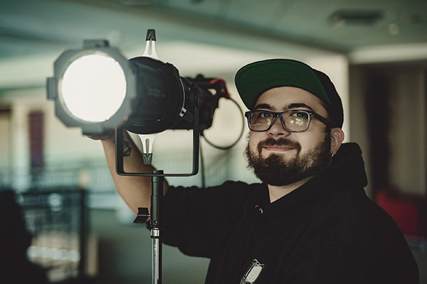man with a film light
