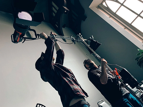 two men adjusting light